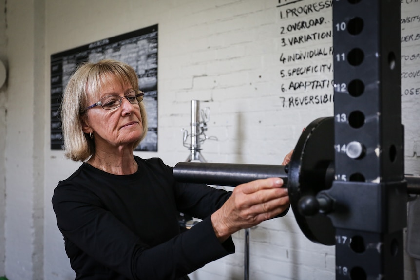 Trish White getting her weights ready for her dead lift.