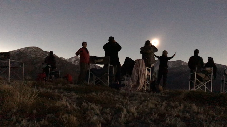 A group gathered on mountain top to view eclipse