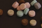 Different coloured ecstasy pills.