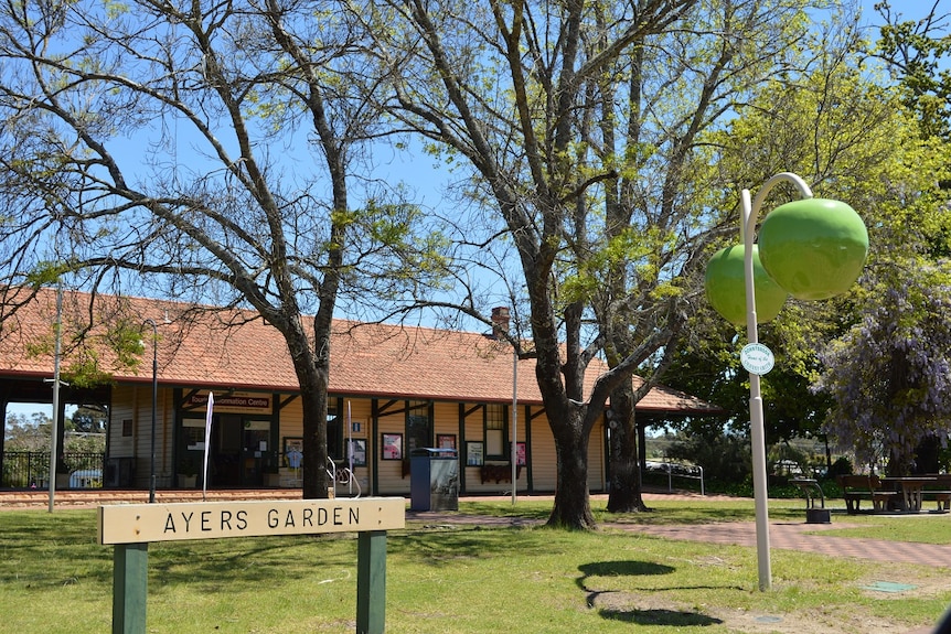 A building sits in parkland.