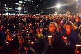 People hold candles at the Hyde Park vigil