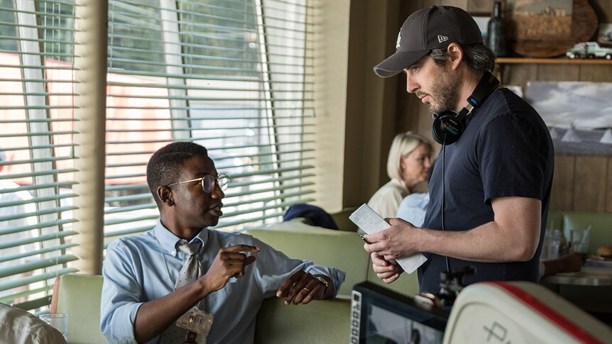 Colour still of actor Mamoudou Athie and director Jason Reitman on the set of 2018 film The Front Runner.