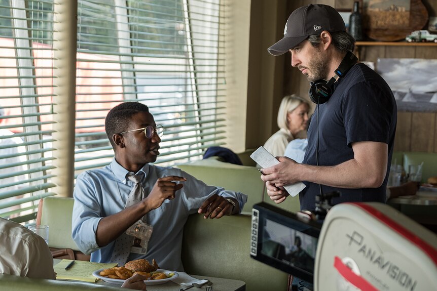 Colour still of actor Mamoudou Athie and director Jason Reitman on the set of 2018 film The Front Runner.