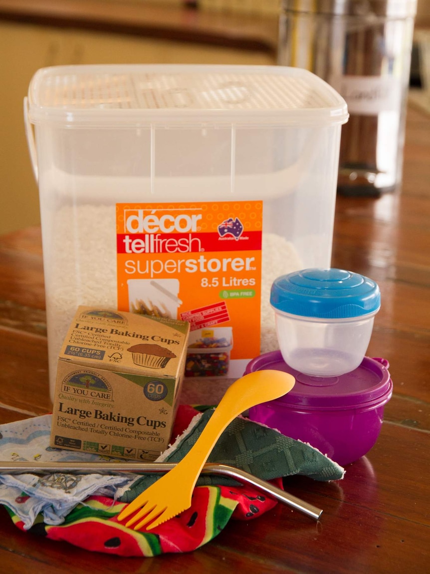 Containers, cloths and utensils on a kitchen counter