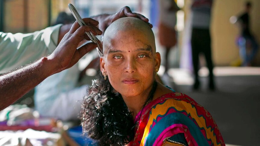 a woman's head is shaved