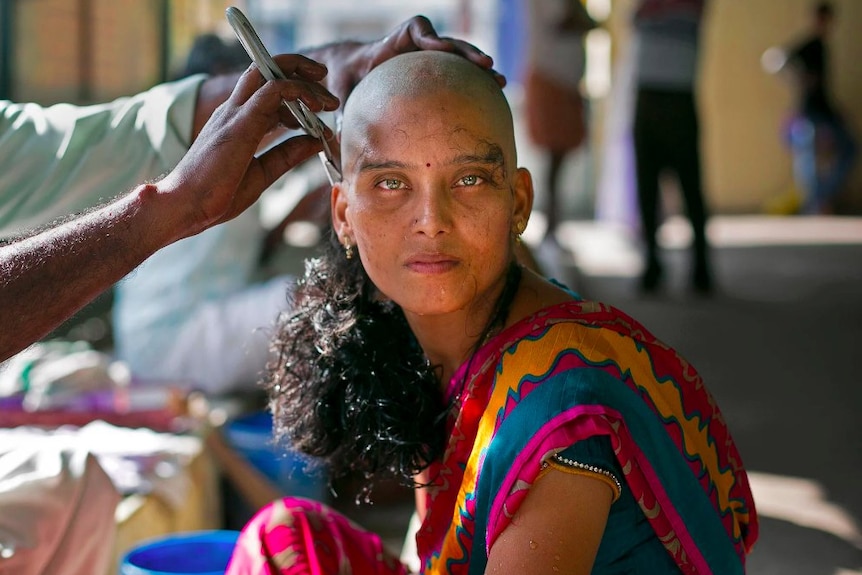 a woman's head is shaved