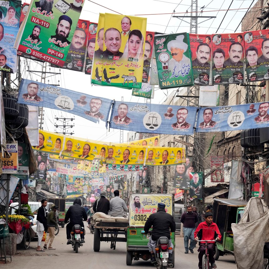 Party banners of election candidates from Pakistan's political parties are displayed on a street.