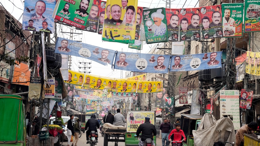 Party banners of election candidates from Pakistan's political parties are displayed on a street.