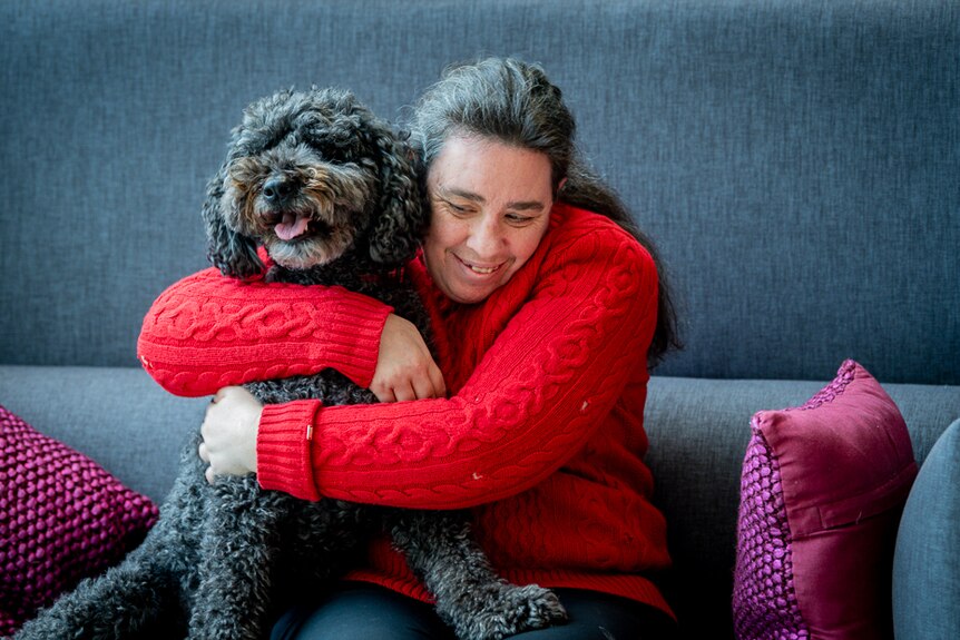 Fiona McKenzie hugs a dog.