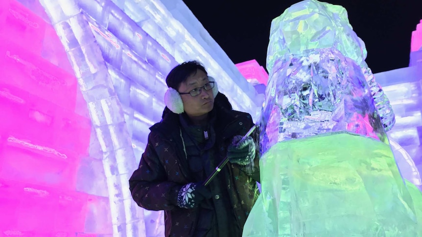 Ice sculptor Sun Jian carves a statue inside an ice buidling at the festival.