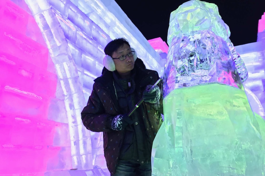 Ice sculptor Sun Jian carves a statue inside an ice buidling at the festival.