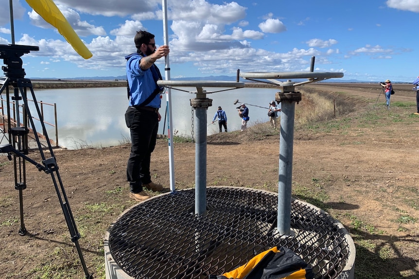 Photo of people looking at equipment.