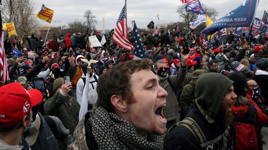 Close up of face of man shouting in a crowd of pro-Trump rioters at the US Capitol in Washington