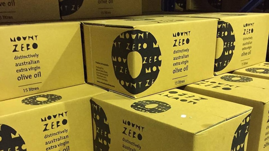 Stacked boxes each containing 15 litres of extra virgin olive oil