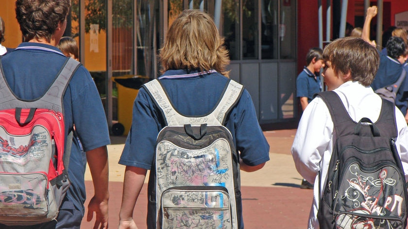 School boys walking with backs to camera.