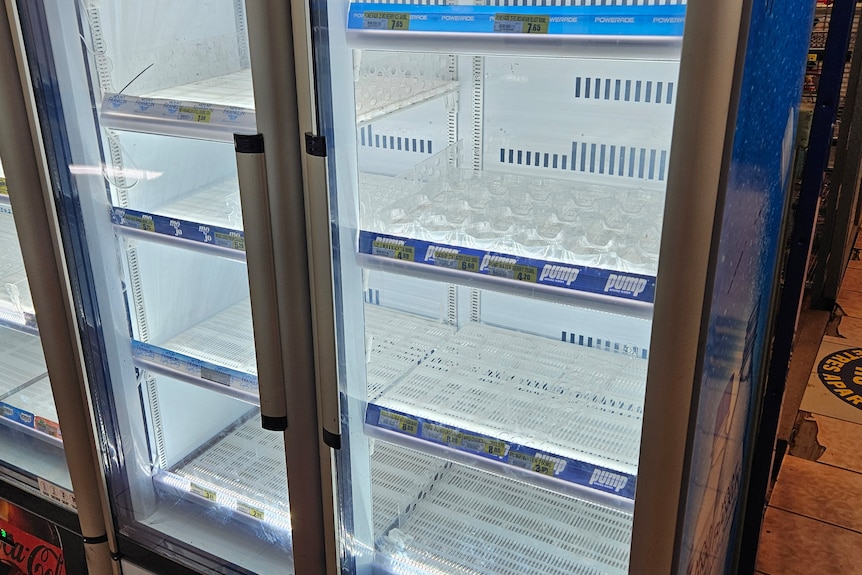 an empty fridge in a community store