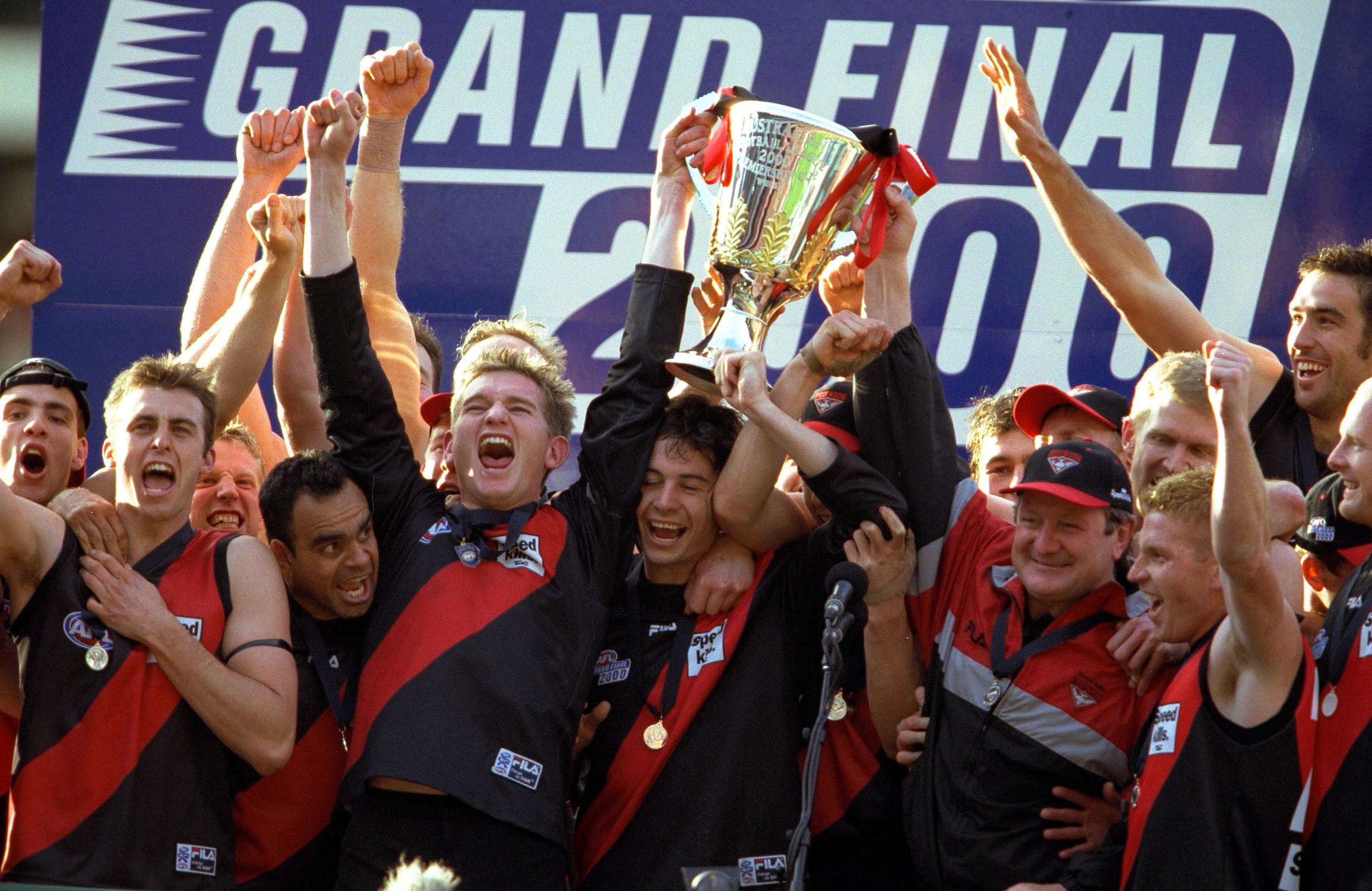 Essendon players celebrate the 2000 premiership win