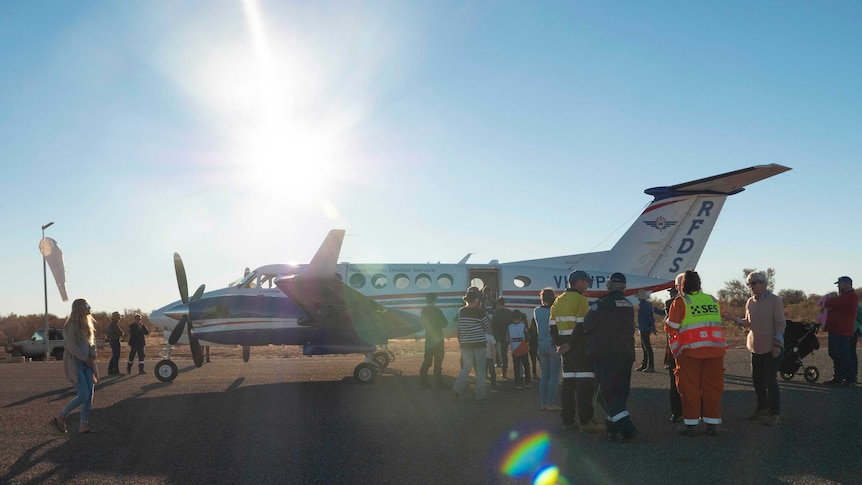An RFDS plane surrounded by a crowd of people.