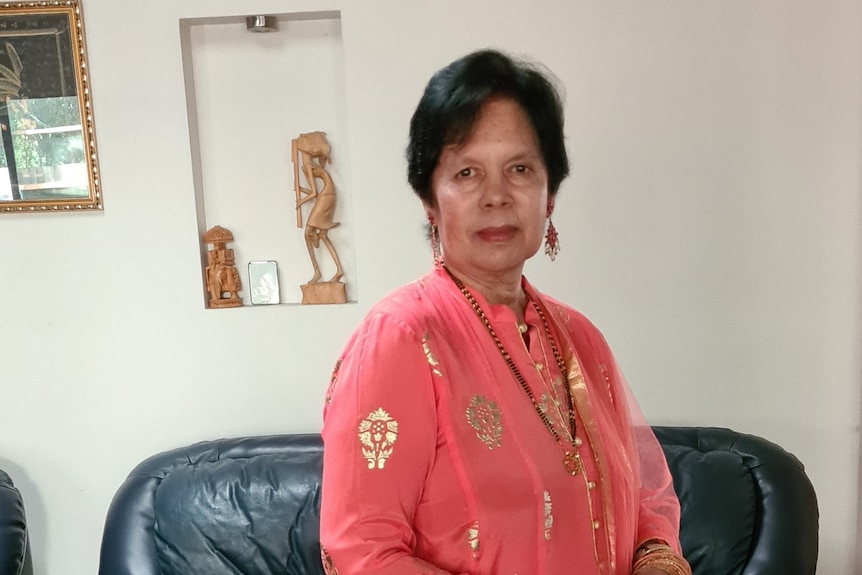 Indira Mohan in tradational Indian dress poses in her loungeroom. 