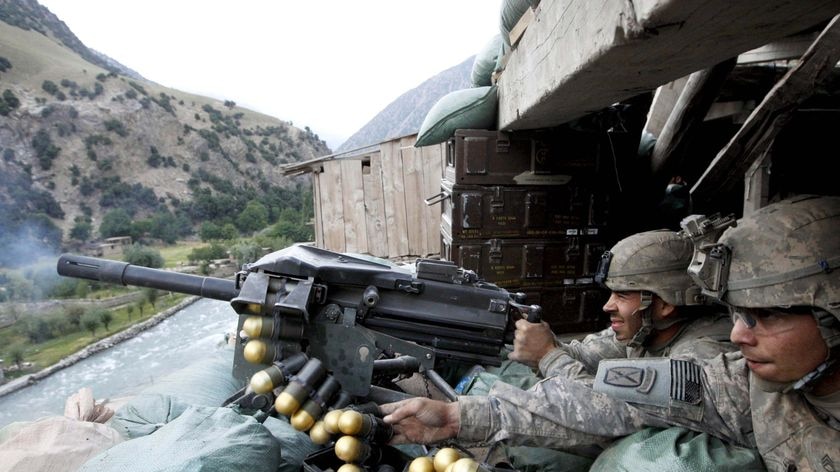 US soldiers fire a grenade launcher