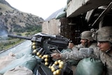 US soldiers fire a grenade launcher