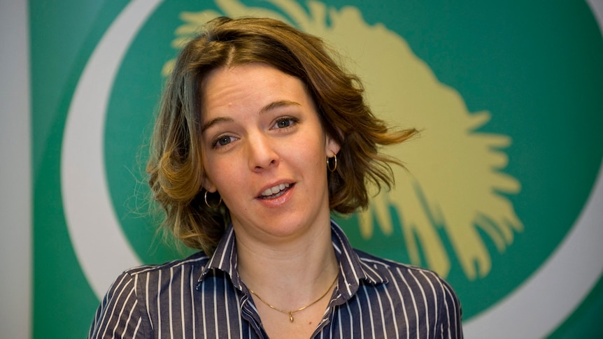 Close up of white woman with short hair.