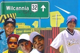 Collage image of members of The Wilcannia Mob in 2002 in front of a road sign.