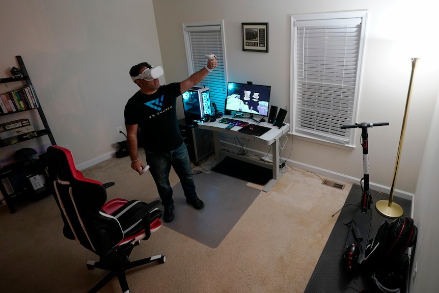 A man wearing a VR headset in a home office.