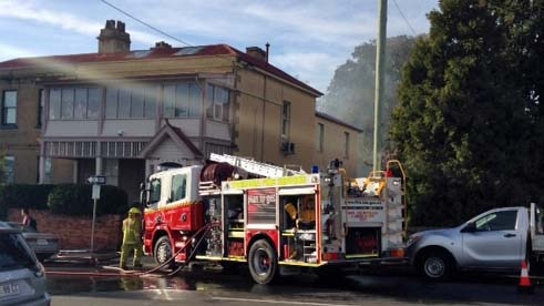 Firefighters attend a fire at a heritage property in central Hobart.