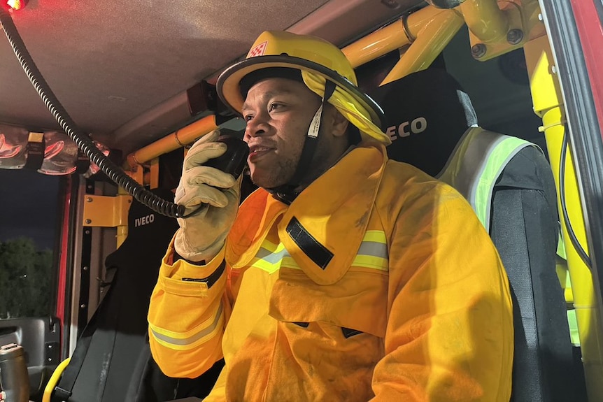 A CFA volunteer speaking in a CB in a fire truck.
