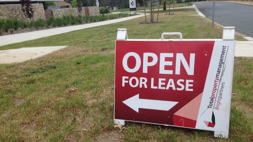 Open for lease sign on footpath outside a property in Canberra.