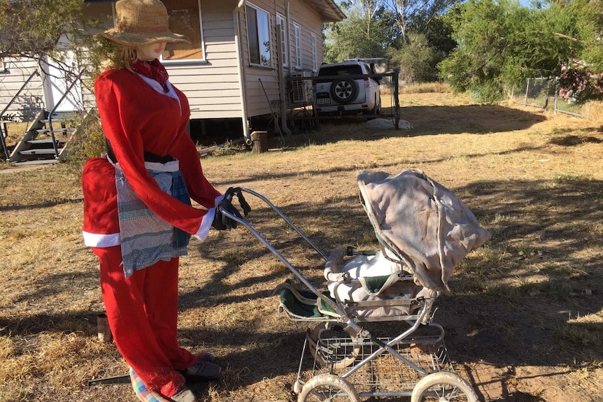 Stuffed model of Mrs Claus pushes a pram in the Isisford Santa display competition, Queensland