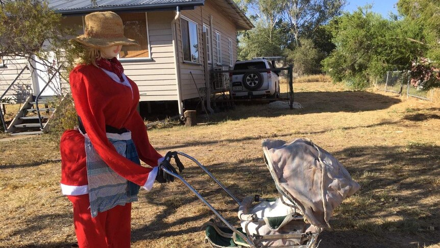 Stuffed model of Mrs Claus pushes a pram in the Isisford Santa display competition, Queensland