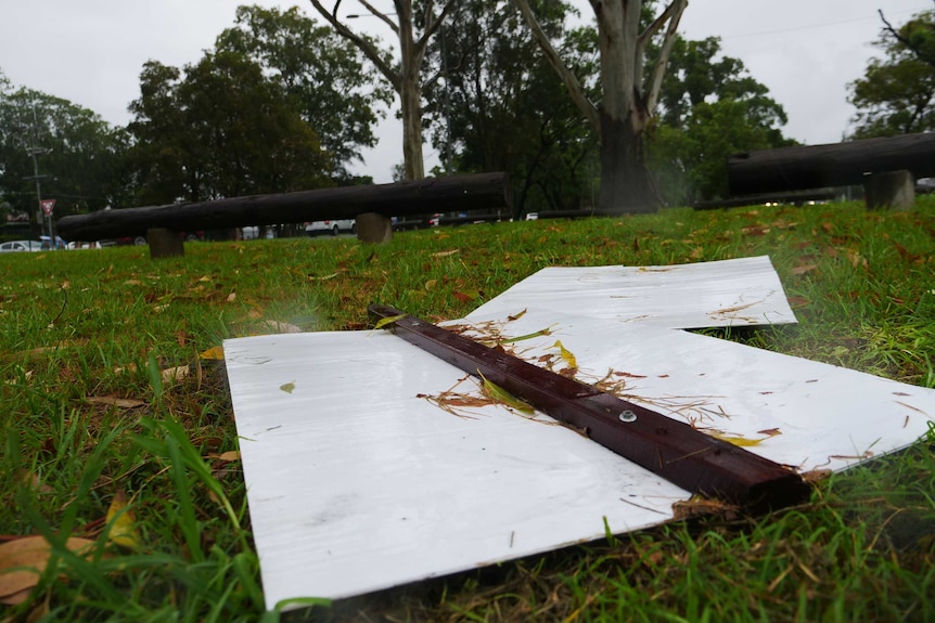 dirty upturned election signs on the grass