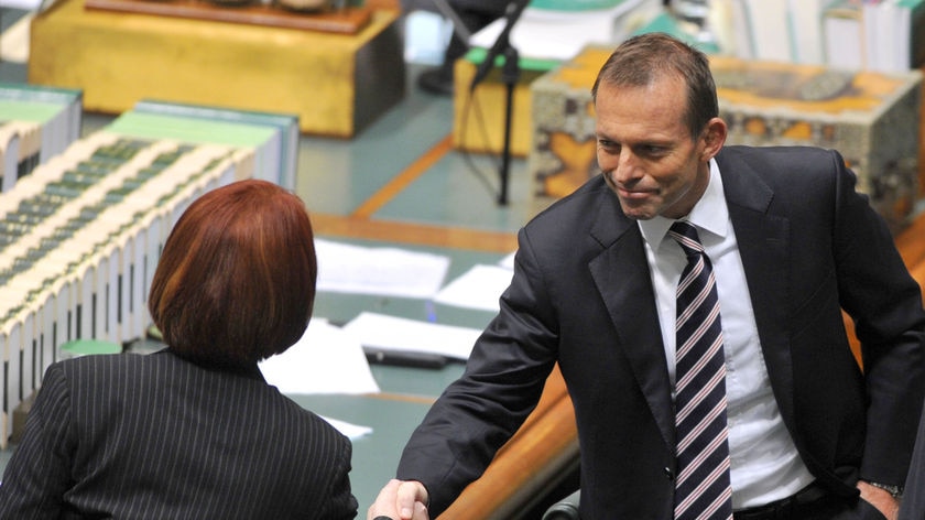Tony Abbott (right) congratulates Julia Gillard