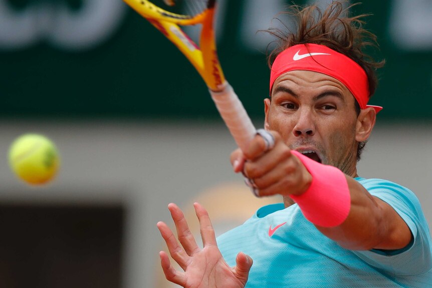 Rafael Nadal hits a forehand at Roland Garros.