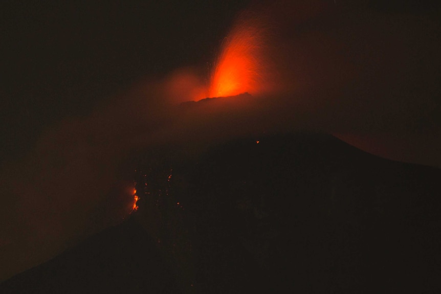 Volcan de Fuego erupts in Guatemala. Lava can be seen blowing out the top of the volcano.