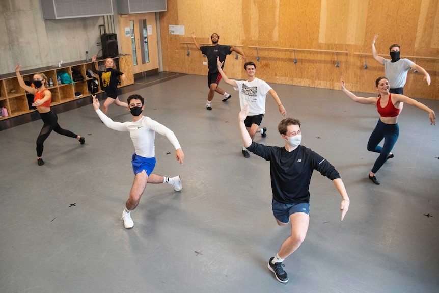 Students observe social distancing with some wearing face masks, as they take part in a dance session.