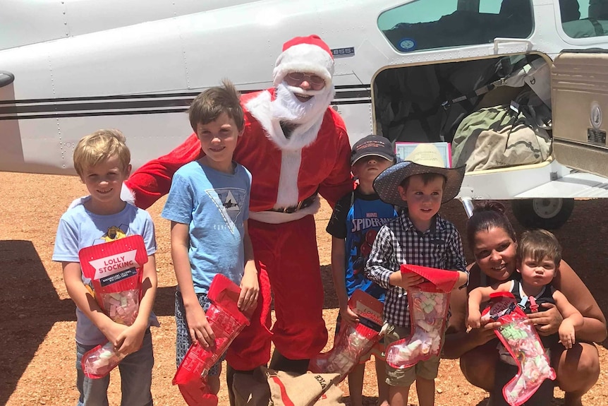 Santa giving children in Innamincka presents