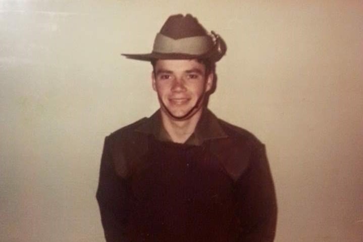 A young Peter Burns posing for a photo in Army uniform