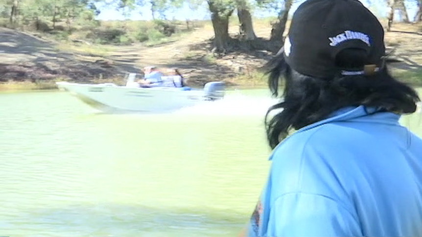 Niall Blair speeds past locals on the Darling River.