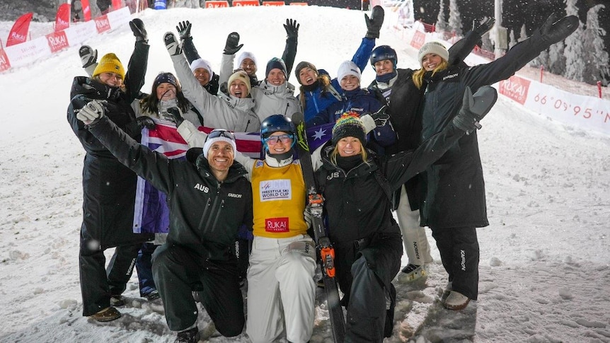 Danielle Scott celebrates with her support team after winning World Cup gold in Finland.