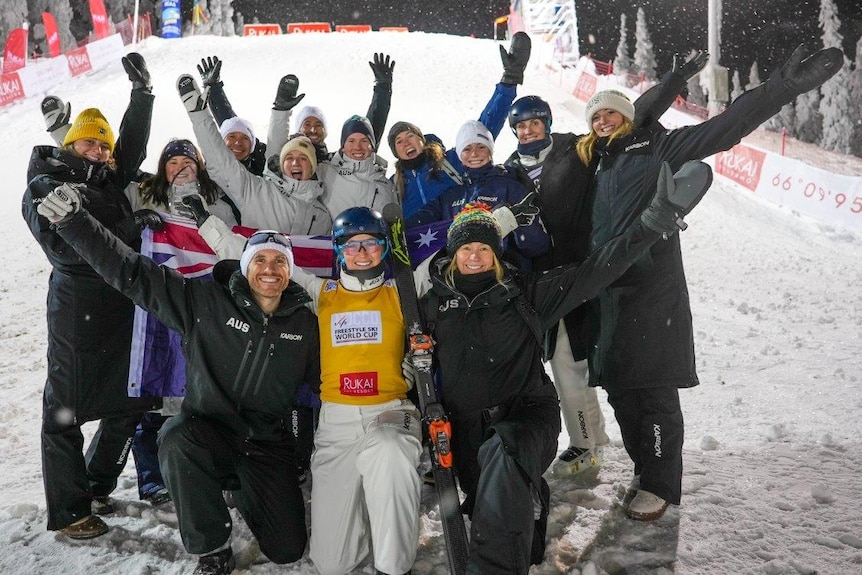 Danielle Scott celebrates with her support team after winning World Cup gold in Finland.