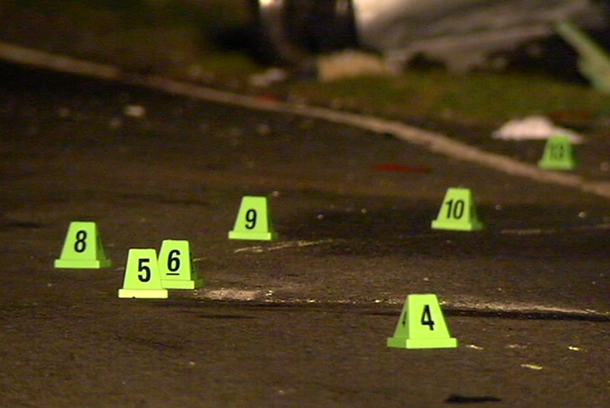 The image shows numbered markers placed by police on the road at the scene of the collision.