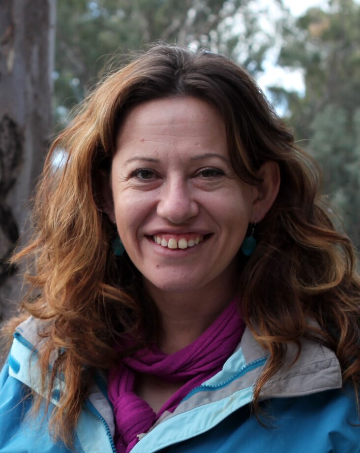 woman with light brown hair smiling at camera 