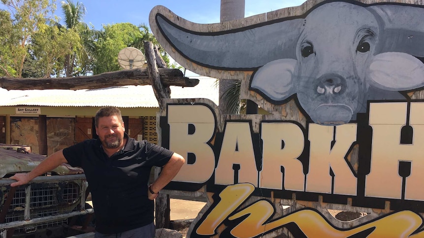 New manager Derrin Broad stands outside the Bark Hut Inn sign which includes a big painted buffalo head.