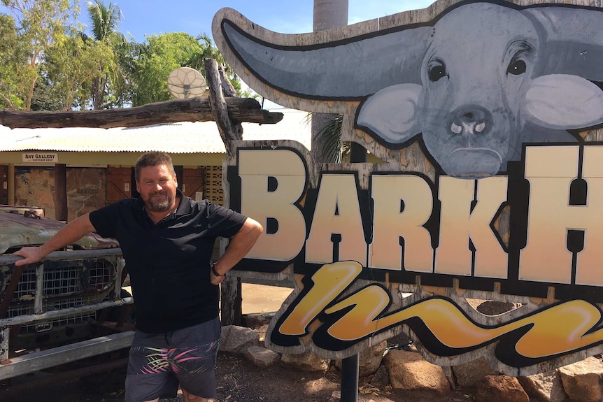 New manager Derrin Broad stands outside the Bark Hut Inn sign which includes a big painted buffalo head.