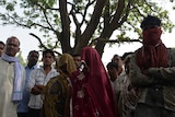 Family and friends of girls who were found hanging from a tree in India