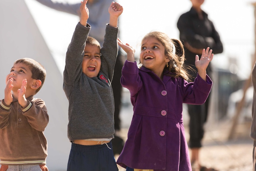 Children smiling with joy at Zelican camp in Iraq