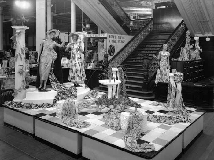 The fabric displayed at in a department story floor, a grand stair case behind.